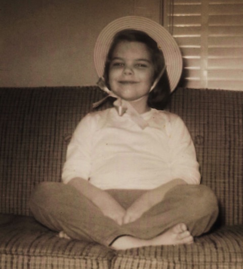 Melinda sitting on the couch with a hat on in 1961